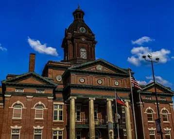 A large building with a clock tower in the middle of it.
